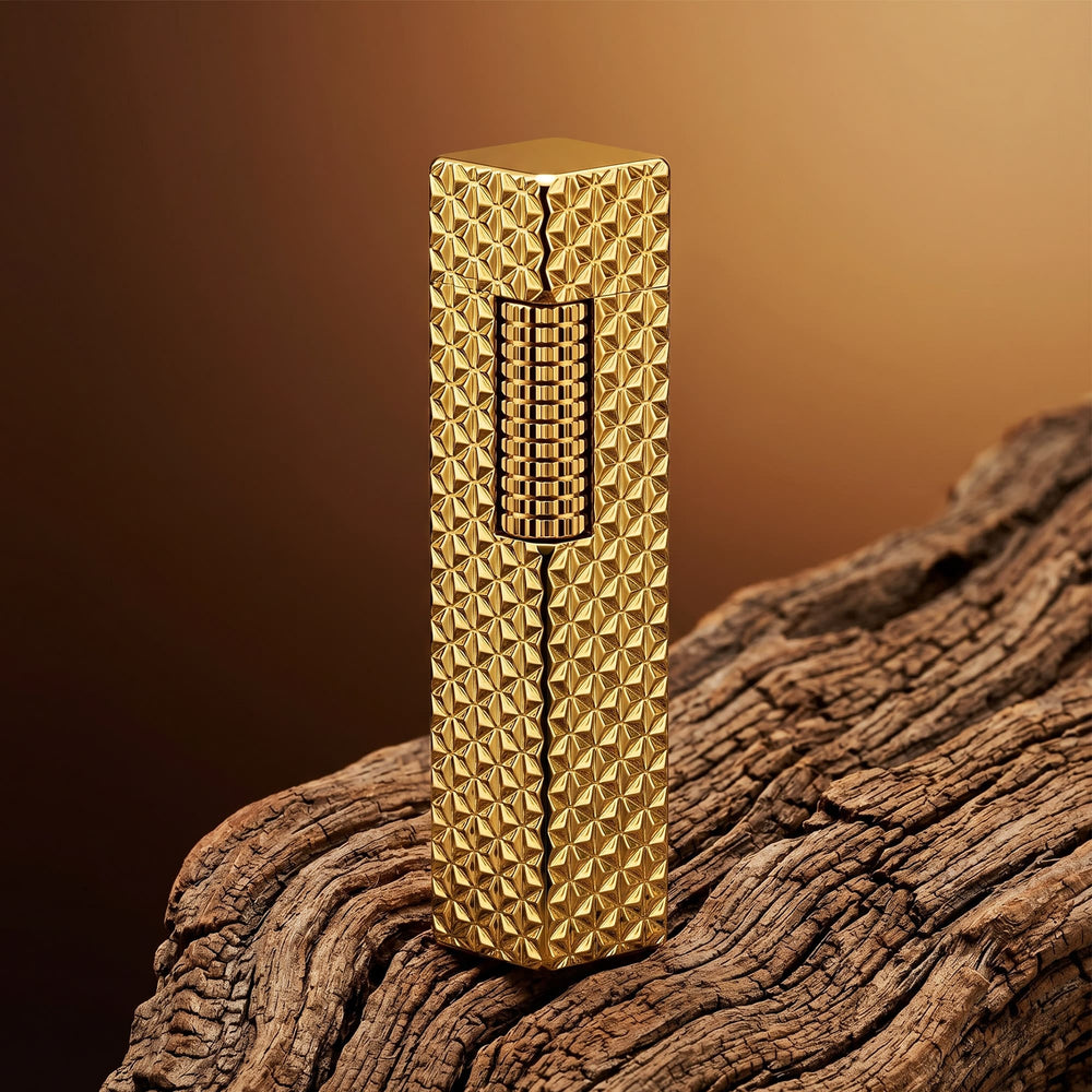 Thorens rectangular lighter with gold starburst pattern and extended roller shown closed, highlighting engraved brass texture and precision side-slide ignition wheel.