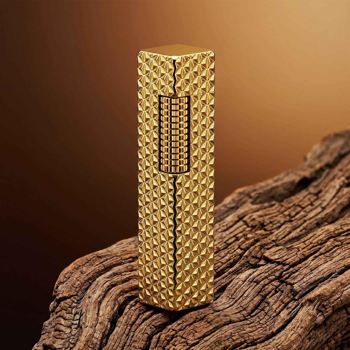 Thorens rectangular lighter with gold starburst pattern and extended roller shown closed, highlighting engraved brass texture and precision side-slide ignition wheel.