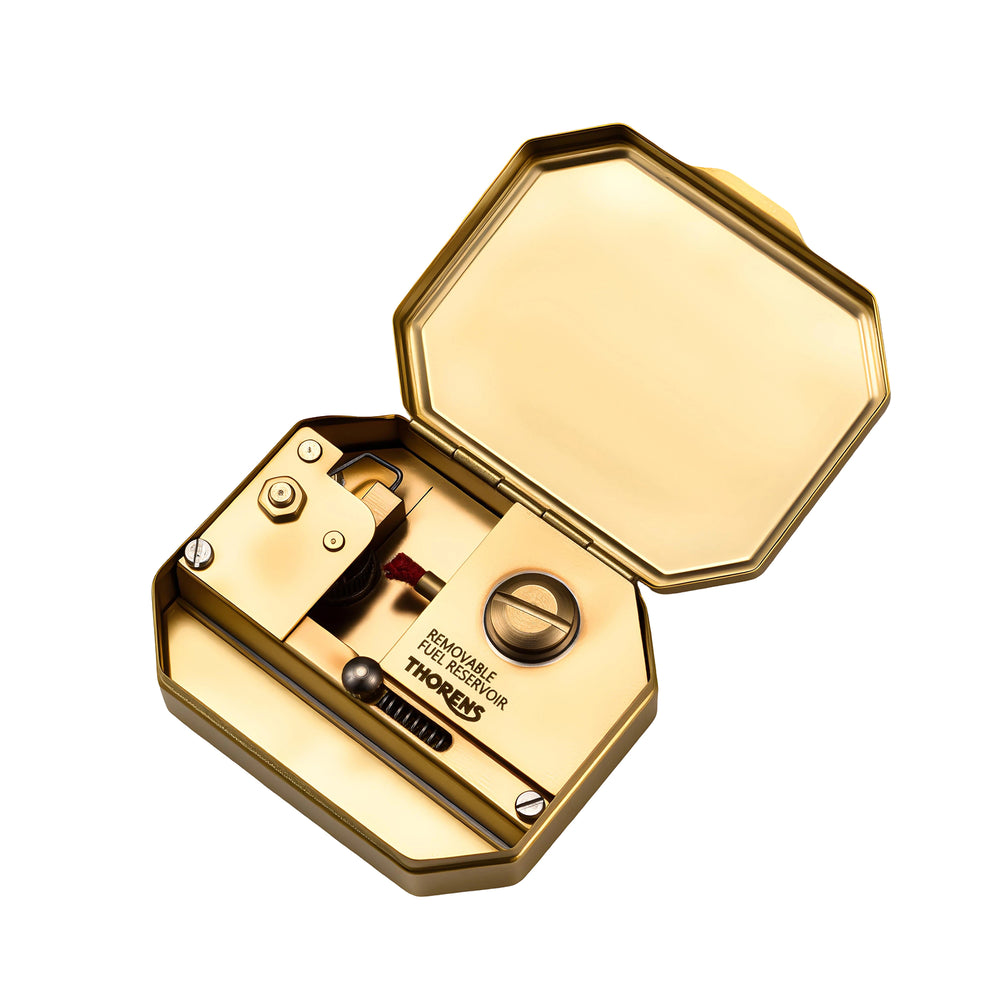 Thorens Steampunk Matchbox Twin Torque lighter opened to reveal brass interior mechanism and removable fuel reservoir with wick assembly.