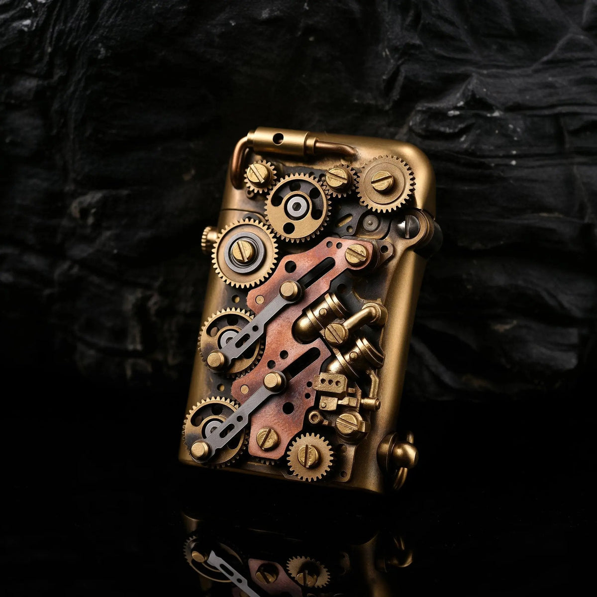 A Thorens Steampunk-Twin Torque side-fill lighter featuring an intricate array of mechanical brass and copper gears and pipes against a dark rock background.