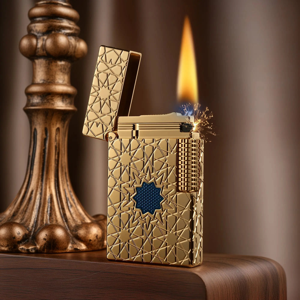A Thorens Stellar Mesh Gold lighter with an open lid and active flame, showcasing the flint spark mechanism and intricate blue mesh star engraving on the gold-plated body.