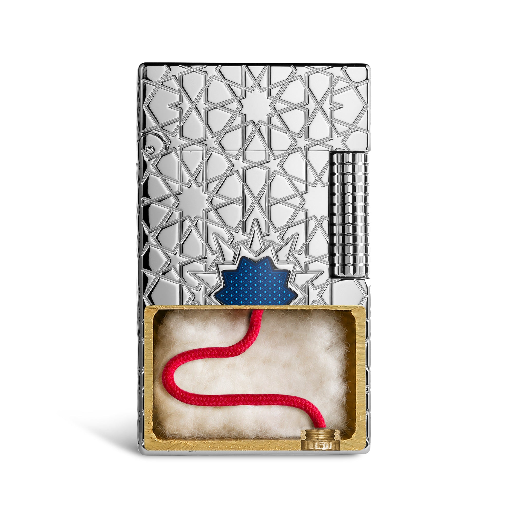 A Thorens Stellar Mesh Silver lighter featuring an intricate geometric star engraving and a central blue mesh inlay, resting on a polished wood surface next to a vintage pedestal.
