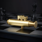 A horizontal side view of the Submarine trench lighter in brushed brass, showcasing its unique nautical silhouette and mechanical thumb-lever on a chessboard.