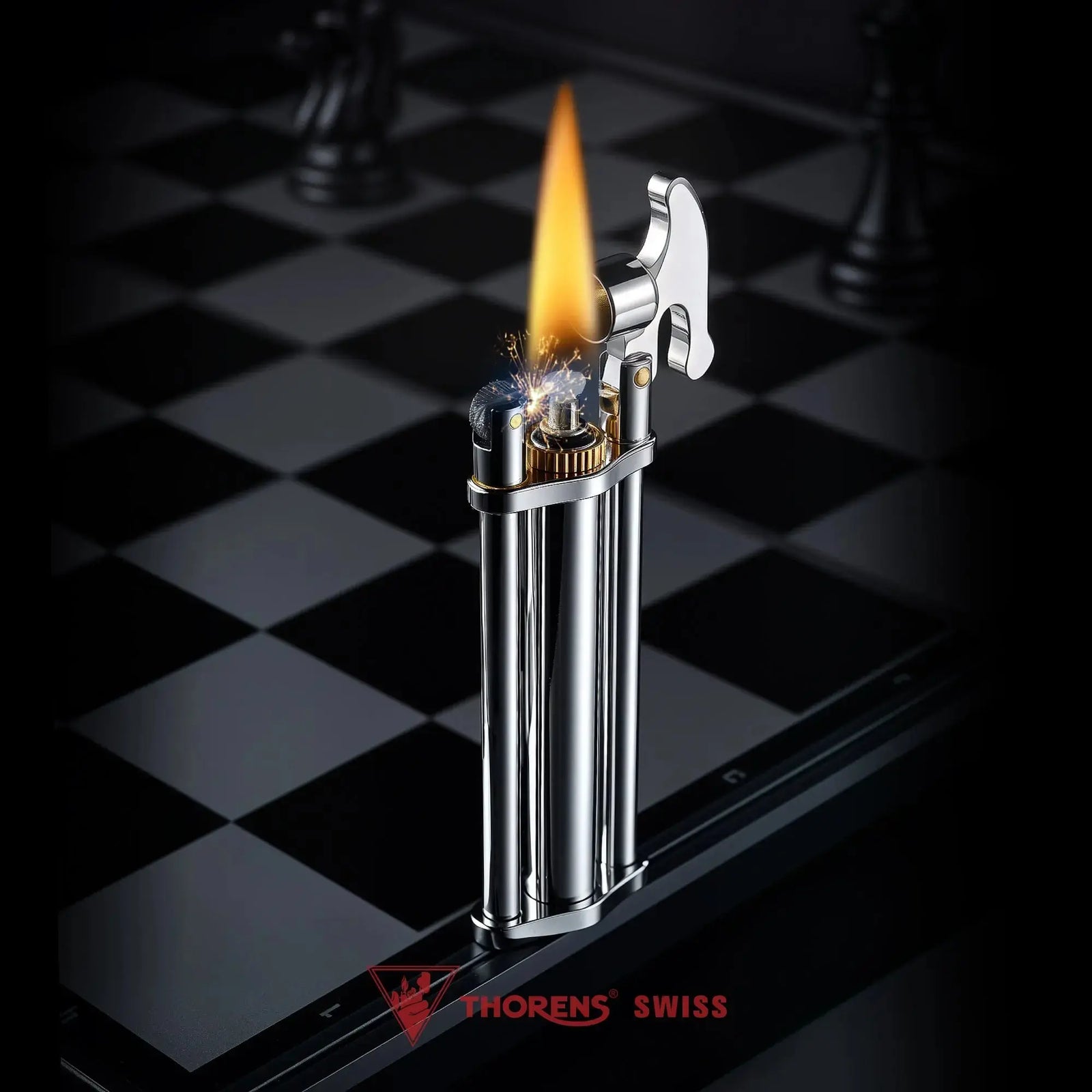 An ignited silver three-section stick lighter with a tall flame, showcasing the unique triple-column structure, brass accents, and engraved ignition lever on a polished chessboard.