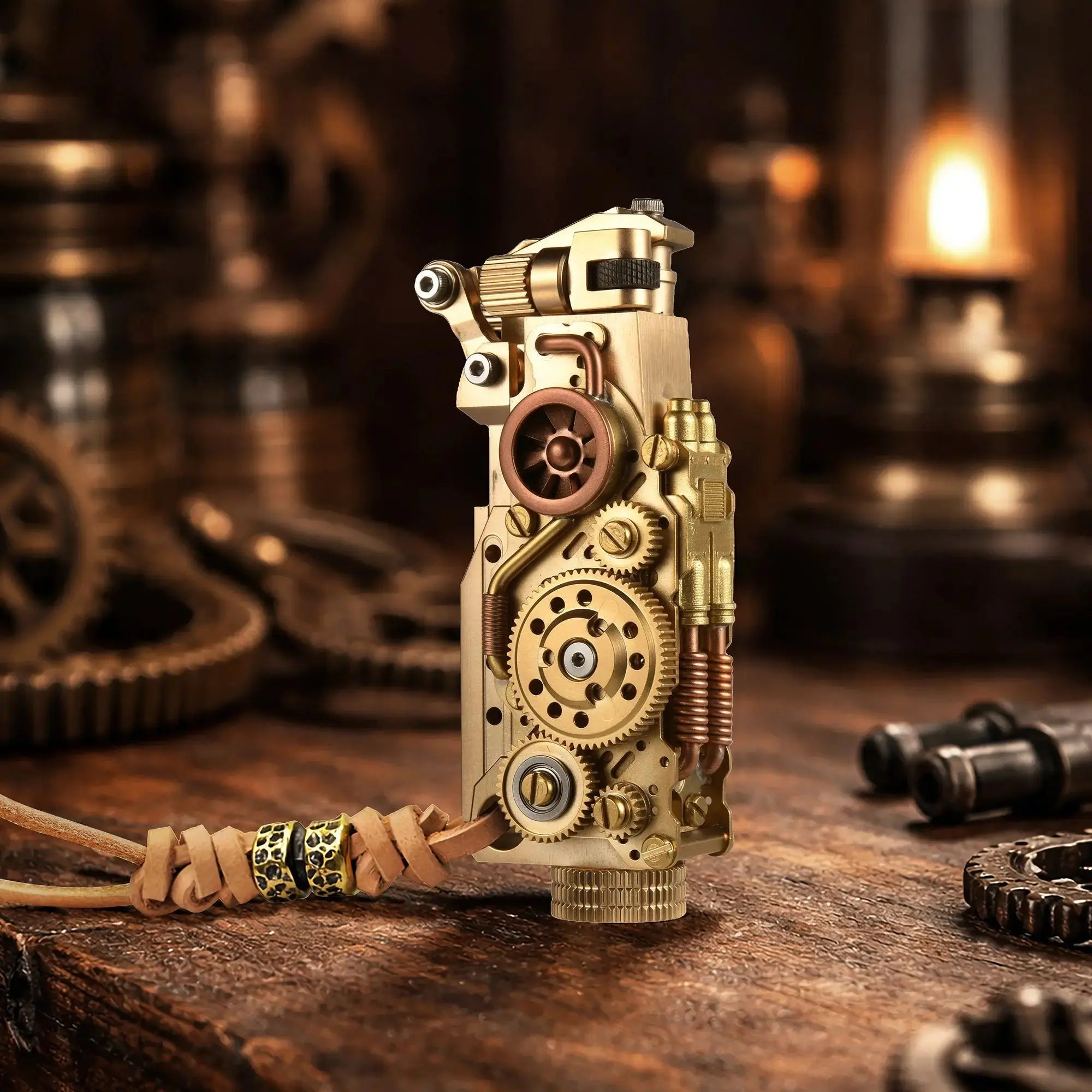 Thorens steampunk mechanical grip grand gear lighter in brass finish standing upright on a warm wood surface, featuring oversized exposed gear detailing, layered brass construction, and a leather lanyard with bead accents