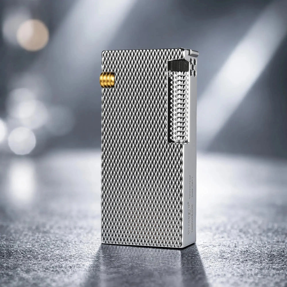 Thorens Slim Cube Silver Mesh lighter standing upright on a softly lit surface, featuring a slim rectangular form, silver mesh texture, polished silver-tone body, and gold-tone accent detail