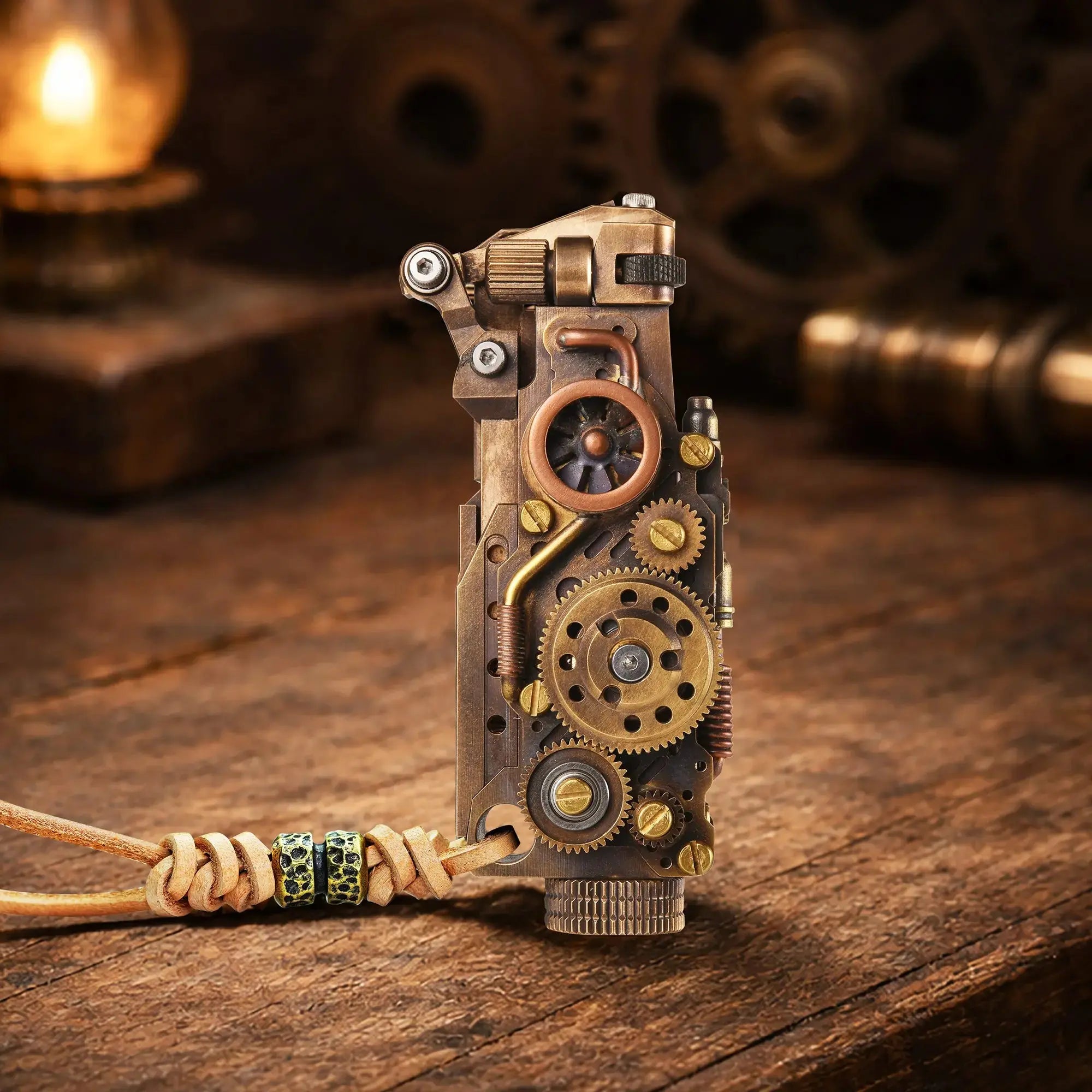 Thorens steampunk mechanical grip grand gear lighter in antique bronze standing upright on a warm wood surface, featuring oversized exposed gear detailing, mixed metal tones, and a leather lanyard with bead accents