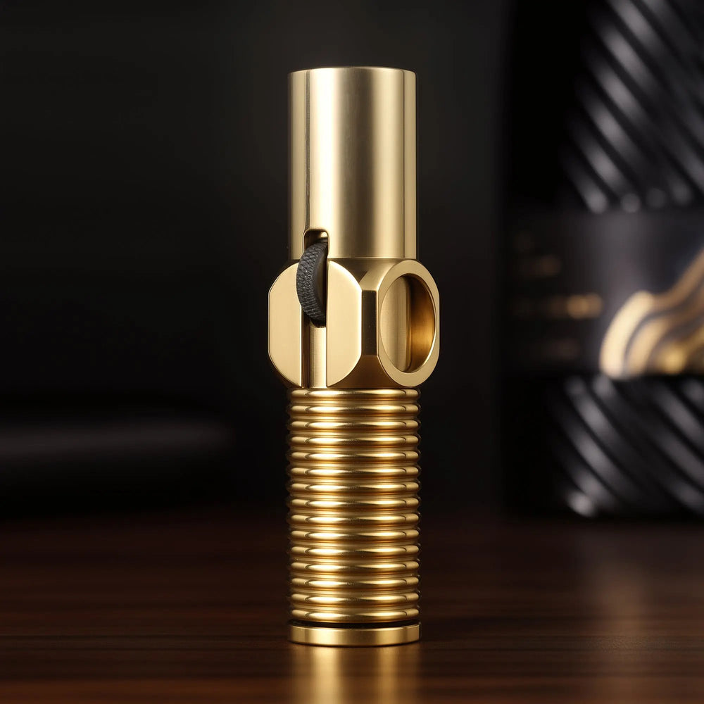 A vertical studio shot of the brass Big Screw Trench Lighter, highlighting the precision-milled threads, the central hex-nut design, and the knurled flint ignition wheel.